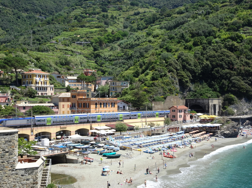 A train passes over Monterosso's other beach