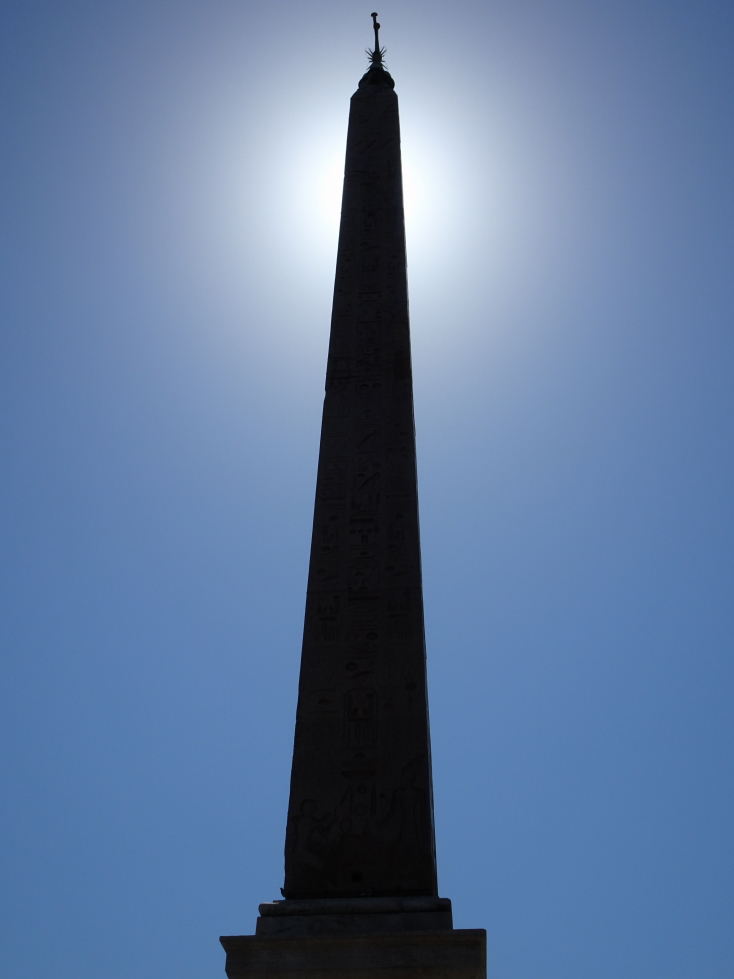 The sun behind the ancient Egyptian Obelisk of Sety I